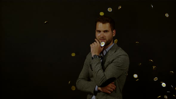 Coins falling on a young man, Ultra Slow Motion alt