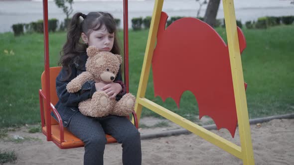 Pensive child on playground.