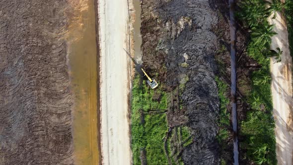 Aerial top down view excavator remove the oil palm tree