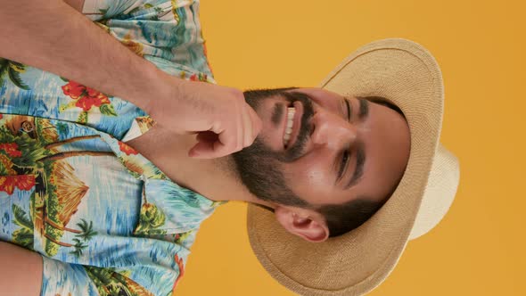 {Portrait of Latin Young Man Who Shakes His Head Suspiciously and Smiles Vertical