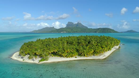 Aerial drone view of a deserted island near Bora Bora tropical island.