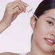 Young Asian beautiful woman dropping serum on face. Woman putting anti-ageing moisturizing serum. - VideoHive Item for Sale