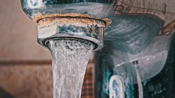 Faucet with Running Water in Slow Motion Macro Shot