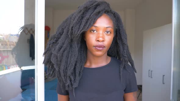 Slow motion shot of young woman with dreadlocks