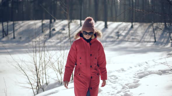 Woman In Parka Walking In Pine Forest. Holiday Vacation Tourist Journey Trip In Cold Day.