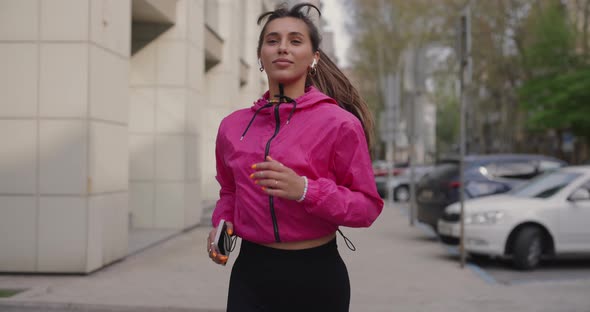 Pretty Sporty Woman Jogging in the City