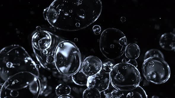 Super Slow Motion Shot of Moving Blue Bubbles Isolated on Black Background at 1000Fps alt