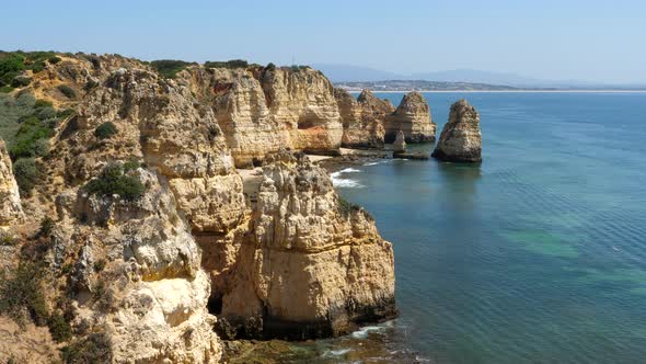 Seascape with rock formation in Ponta da Piedade on sunny day. Static