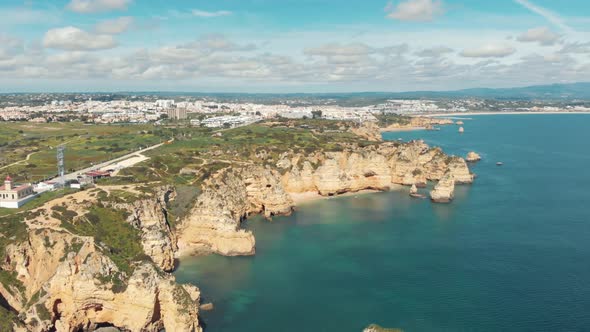 Farol da Ponta da Piedade overlooking rock formations and cliffs. Lagos Atlantic sea coastline