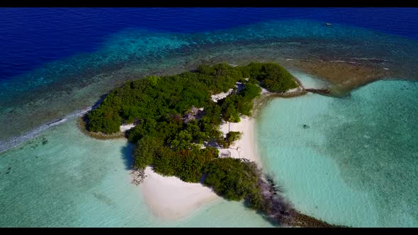 Aerial drone tourism of beautiful resort beach lifestyle by turquoise ocean with white sand backgrou
