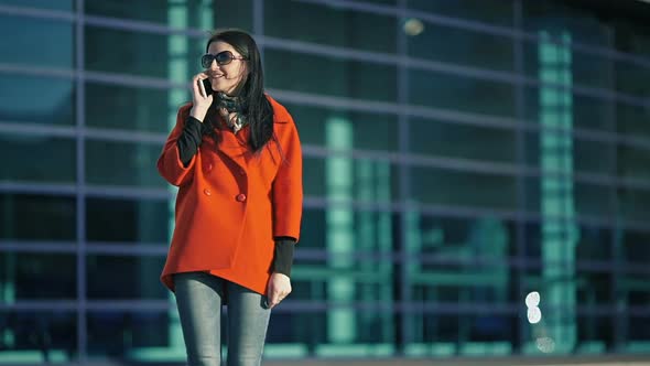 Business Girl Talking on the Phone in the Street