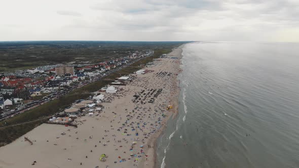 Drone footage of a crowded beach along the coast of Zandoort, Netherlands.