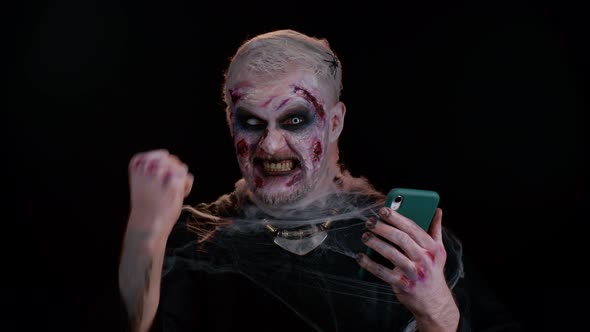 Happy Excited Sinister Man Halloween Zombie Use Smartphone Celebrating Lottery Win Success Luck