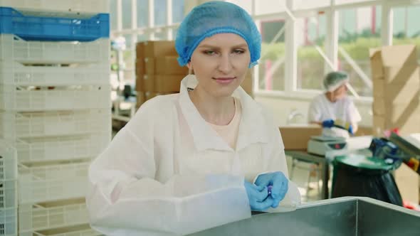 Candy Factory. Factory Worker Checking Packing Machine.