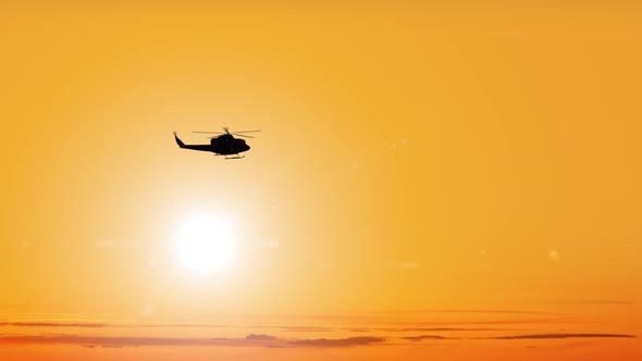 Dark Silhouette of Helicopter Flies Against Bright Sun