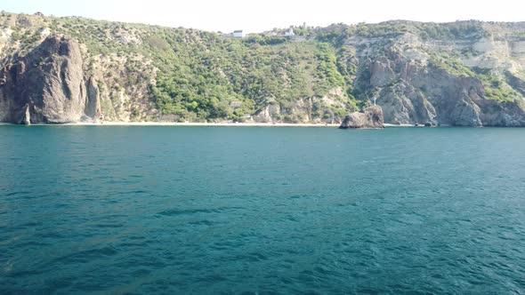 Aerial View From Above on Calm Azure Sea and Volcanic Rocky Shores