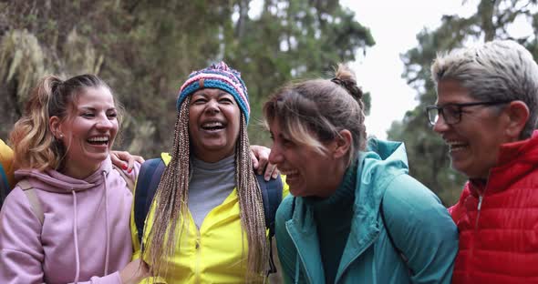 Multiracial women having fun during trekking day into the wood