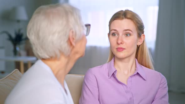 Family mother and daughter talking on a sofa