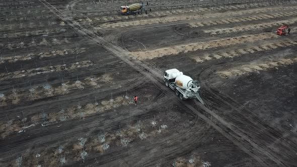 High Angle View of a Field with Lots of People and Trucks Solar Power Station