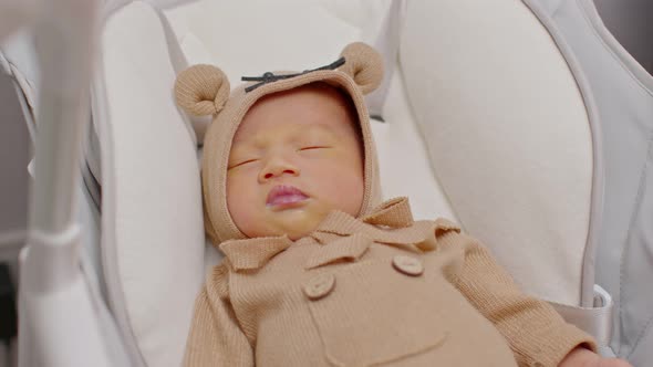 A happy newborn infant lying sleep on a baby bed