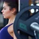 A beautiful athletic young brunette woman in sportswear in the gym performs exercises with barbell. - VideoHive Item for Sale