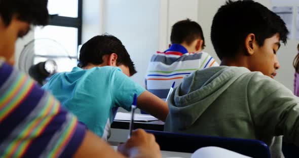 Students doing homework in classroom