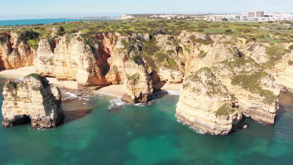 Intimate sandy coves surrounded by towering eroded cliffs in Lagos, Algarve, Portugal