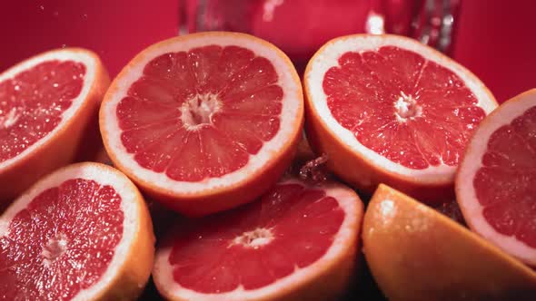 Slow Motion Shot of Grapefruit Water Splashing Through Grapefruit Slices