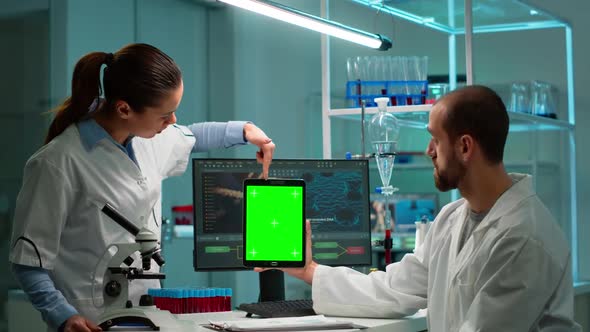Medical Research Scientists Using Notepad with Green Screen