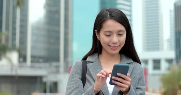 Businesswoman use of smart phone in Hong Kong