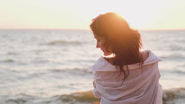 Portrait of a Beautiful Woman in the Background of the Setting Sun. Hair in the Wind. Portrait of a