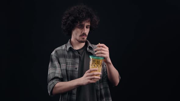 The Handsome Handsome and Thirsty Boy Drinks From a Glass with a Straw is Amazed By the Wonderful