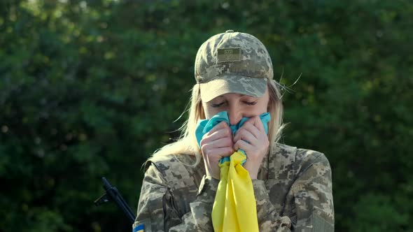 Female Patriot Soldier Holds Ukrainian Flag and Praying with Hope