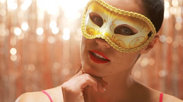 Young woman wearing a carnival mask