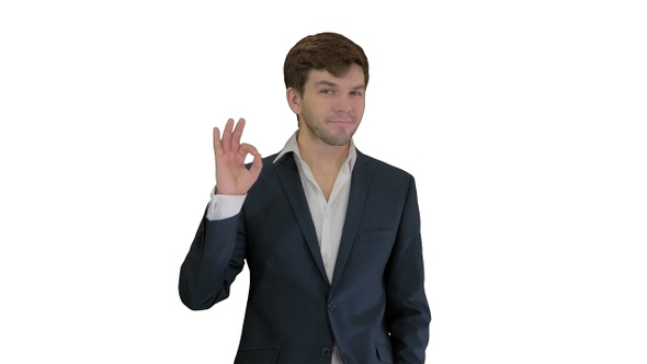 Young business man going thumbs up and ok gesture after