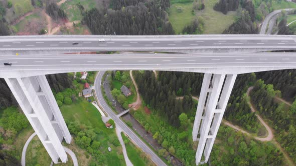 Aerial View of the Highway Viaduct on Concrete Pillars with Traffic in Mountains