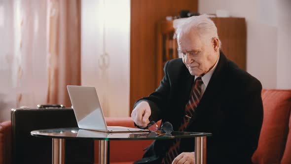 Elderly Grandfather - Old Grandfather Is Taking Off His Glasses Reloading a Gun