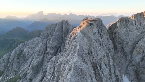 Dolomites mountains peaks with a hiking path on a summer sunrise