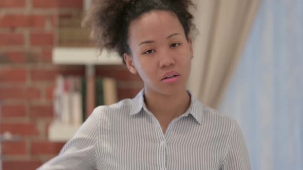 Portrait of African American Woman Showing Thumbs Down