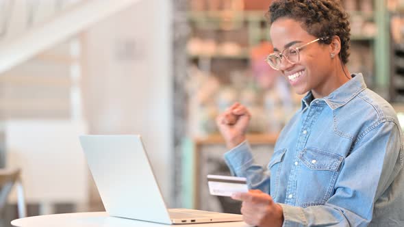 African Woman Having Online Payment Success on Laptop 