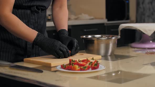 Pastry Chef Cuts Strawberries Into Halves for Cake Decorating