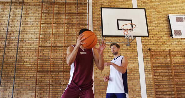 Basketball players playing in the court