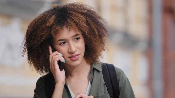 Young African American Woman Irritably Holding Phone to Ear and Displeased Very Hard to Hear