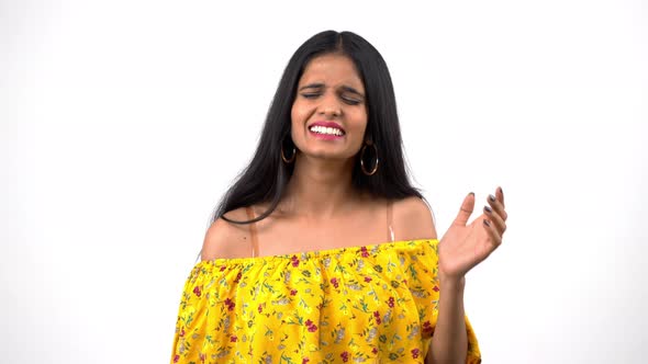 Impressed Indian girl laughing at someone's joke