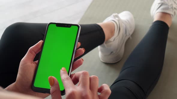 Green Screen Smartphone in Hands of Sports Woman Closeup