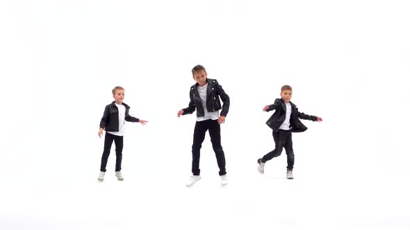 Kids Are Dancing a Modern Dance on the White Background in Black Leather Jackets and Jeans. Slow