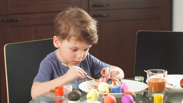 Little Boy Decorating Easter Eggs for Holiday