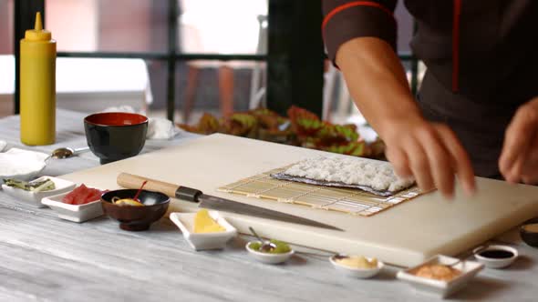 Hands of Man Preparing Sushi.