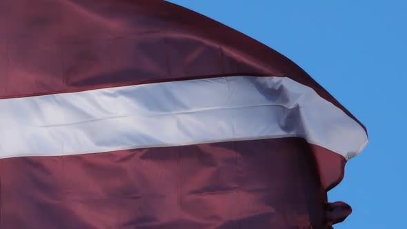 The national latvian flag waving in the wind.