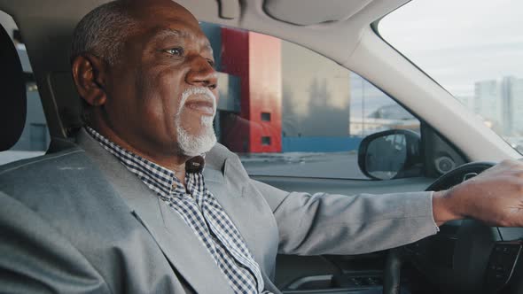 Old African American Man Driving Car Serious Pensive Elderly Male Leaves Parking Lot Mature